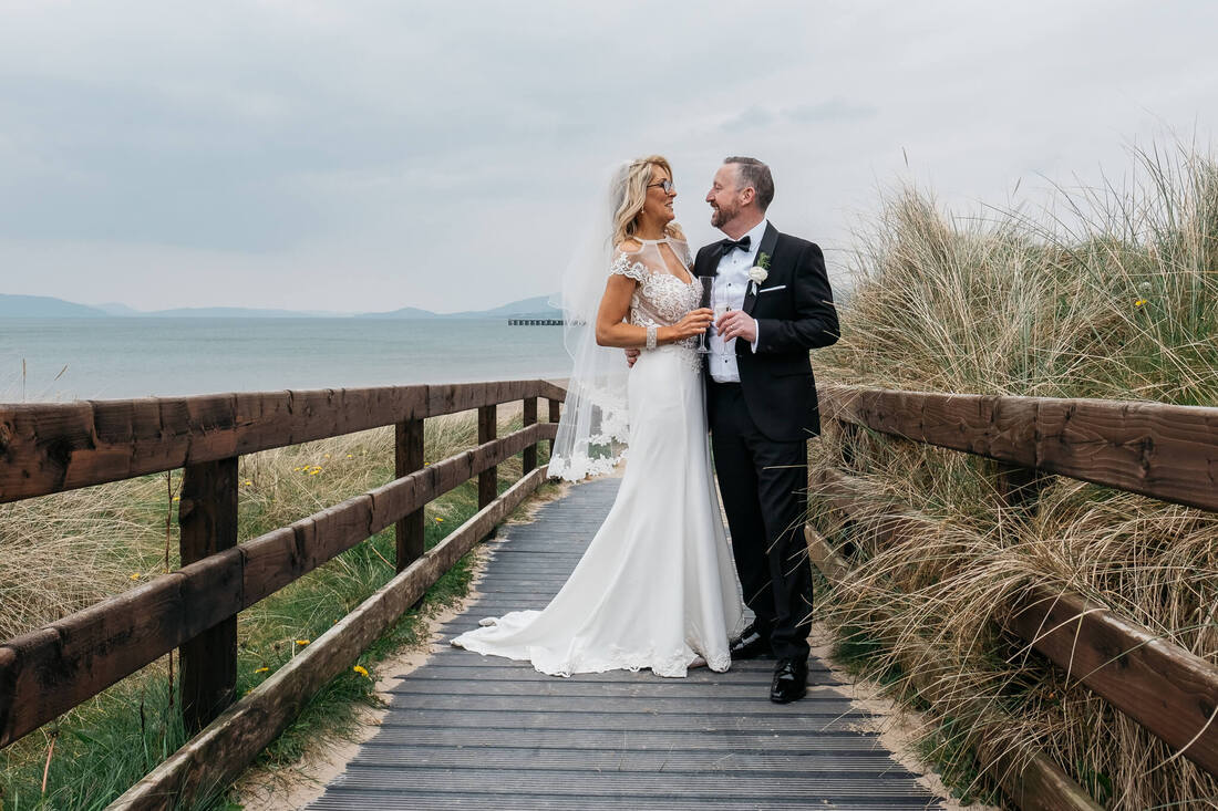 A bride and groom on the walkway to Ludden Beach in Donegal