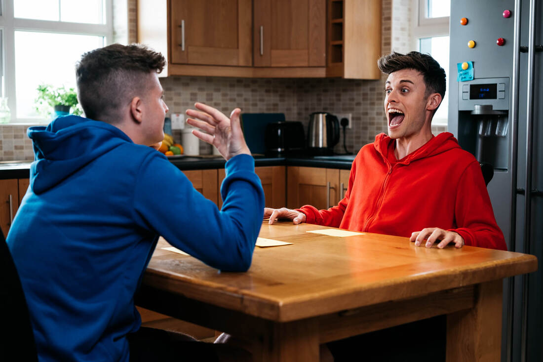 Adam B & Joe Tasker sat at a kitchen table during the recording of BBC Studio's Bros In Control TV Show