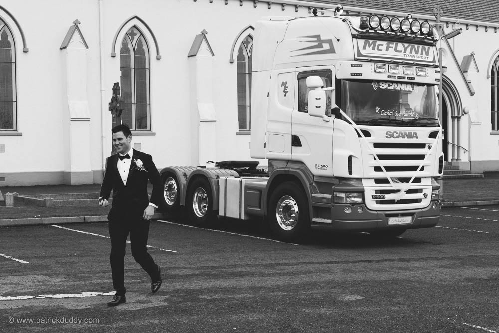 Black and white wedding photograph of groom arriving at chapel prior to Ballyscullion Park Wedding Venue by Patrick Duddy Candid & Documentary Wedding Photography