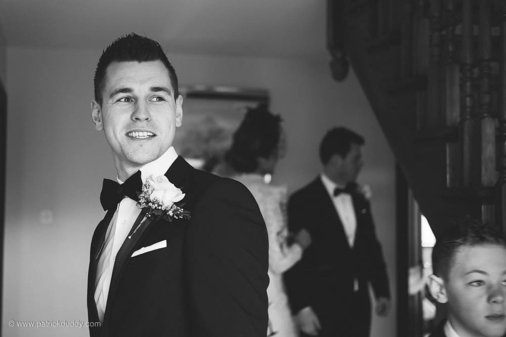 Black and White photography of groomsman waiting in grooms home before travelling to Ballyscullion Park Wedding Venue by Patrick Duddy Candid & Documentary Wedding Photography