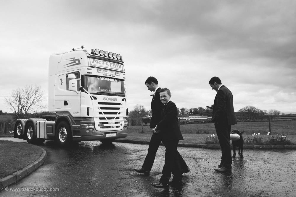 Black and white wedding photograph of groom heading to Ballyscullion Park Wedding Venue by truck taken by Patrick Duddy Wedding Photography