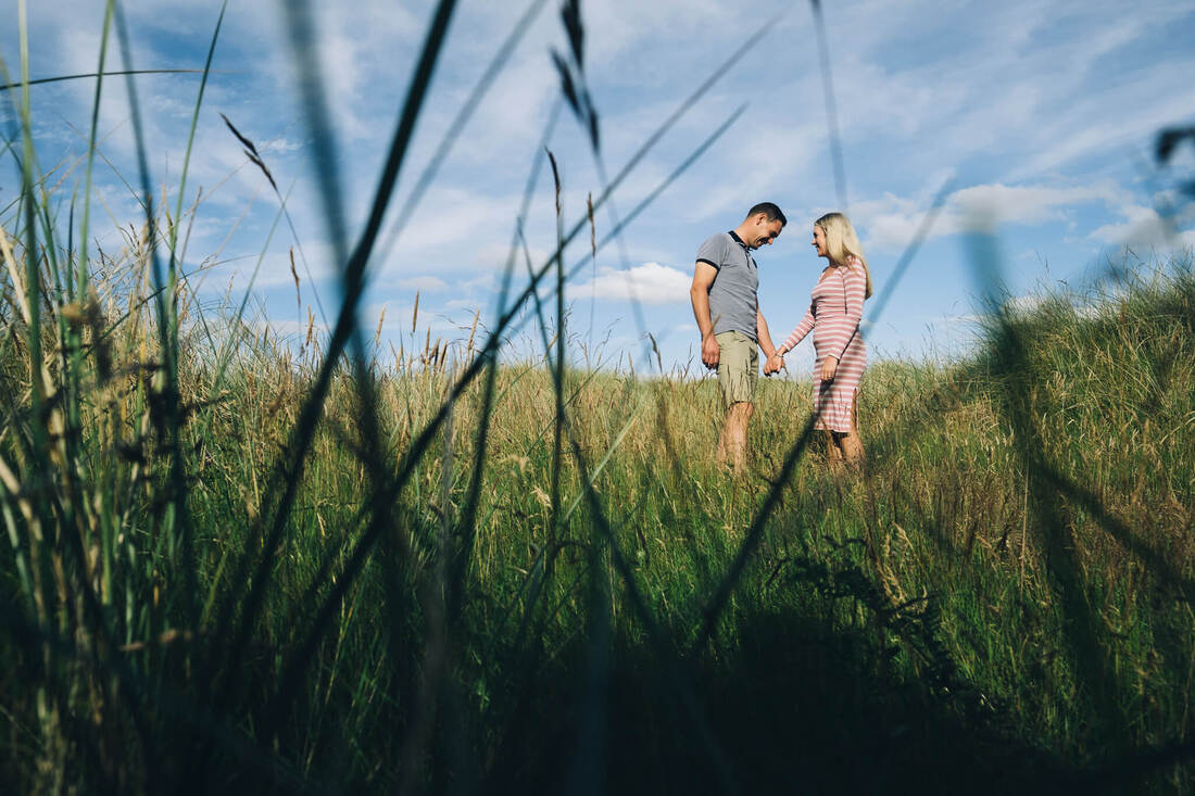 PictureA couple walking through the long grass on the way to the beach in Donegal by Patrick Duddy Photography