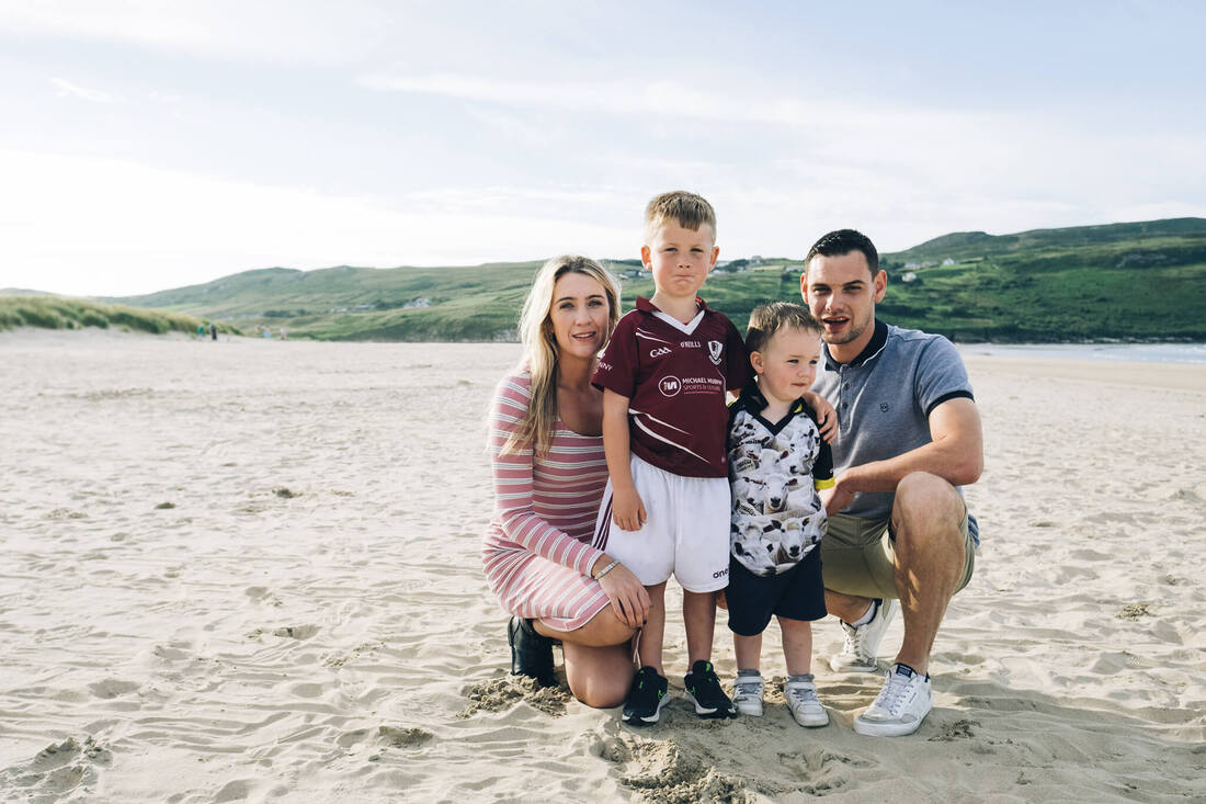 A portrait of a family on the beach taken in Donegal by Patrick Duddy Photography