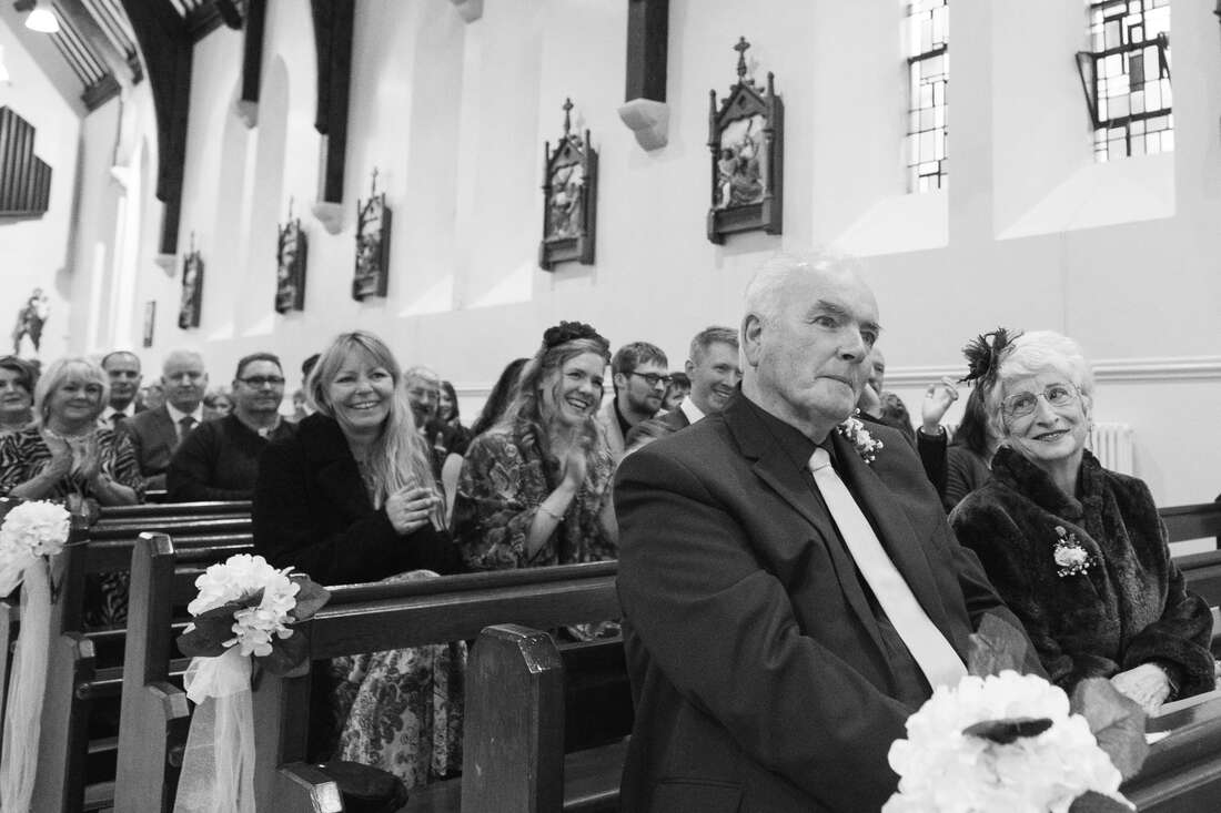 Photographs of the Bride, Groom, Priest and Guests during the Wedding Ceremony in Drung County Donegal Patrick Duddy wedding photography