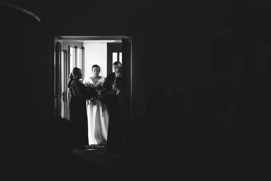 The bride closes her eyes as she takes a moment to compose herself prior to walking down the aisle