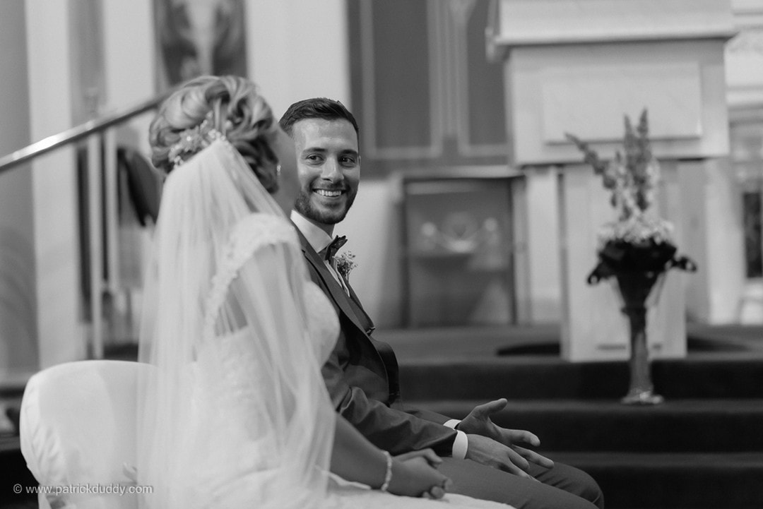 Bride & Groom sharing a smile during their wedding ceremony in Derry