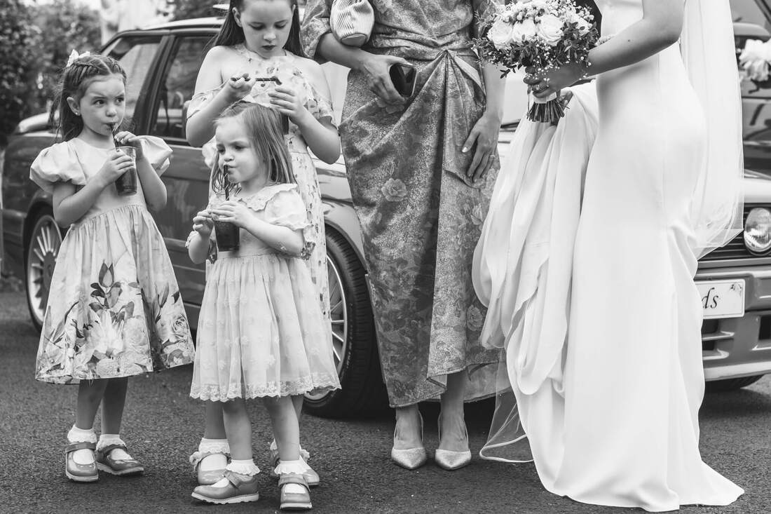 Young wedding guests enjoying refreshments while the bride chats beside them